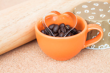 Image showing Heart cookies cutter in cup of coffee bean  