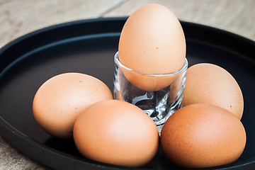 Image showing Many eggs in a black tray