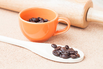 Image showing Roast coffee bean in a cup and wood spoon 