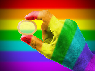 Image showing Male giving a condom, rainbow flag pattern