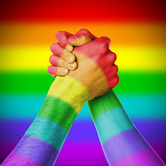 Image showing Man and woman in arm wrestlin, rainbow flag pattern