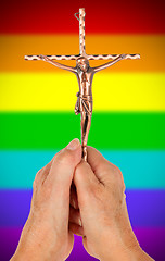 Image showing Old woman with catholic crucifix, isolated, rainbow flag pattern