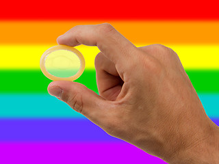 Image showing Male giving a condom, rainbow flag pattern