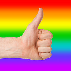 Image showing Image of a mans hand showing thumb up, rainbow flag