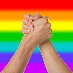 Image showing Man and woman in arm wrestlin, rainbow flag pattern