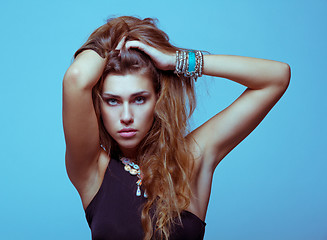 Image showing White young woman in black clothes posing studio