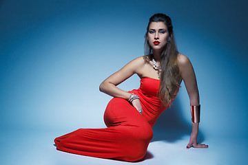 Image showing Young glamour woman in red dress long hair