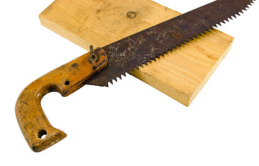 Image showing retro rusty hand saw and wood board part on white 