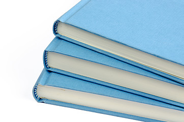 Image showing A fan of three blue books on a white background