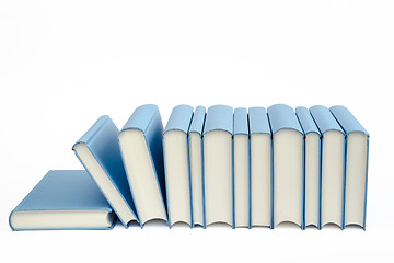 Image showing A group of blue books in a row on a white background