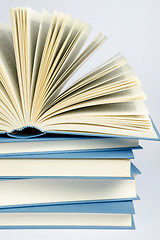 Image showing A stack of blue books on light blue background