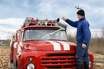 Image showing A man washes the fire truck