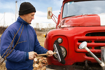 Image showing A man washes the old fire truck