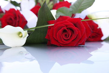 Image showing Bouquet of fresh red roses and arum lilies