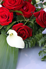 Image showing Arum lily in a bridal bouquet of red roses