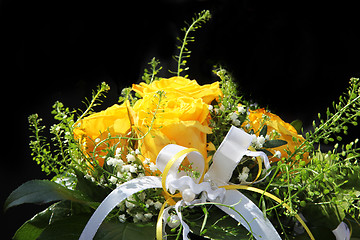 Image showing A bouquet of flowers with a decorative ribbon