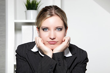 Image showing Young businesswoman sitting thinking