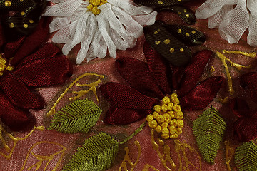 Image showing The red and white embroidered flowers