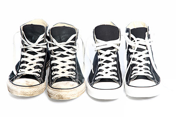 Image showing Two pairs of sneakers - one old, one new