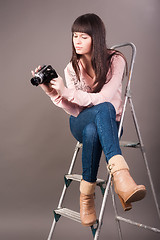 Image showing young woman with video camera
