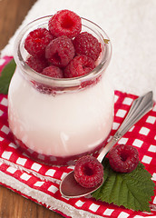 Image showing White yogurt with strawberry and spoon