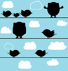 Image showing Silhouette of birds owl on a wire with clouds