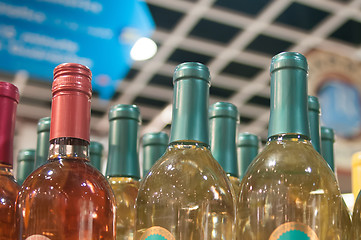 Image showing Wine bottles shot with limited depth of field on display in a li