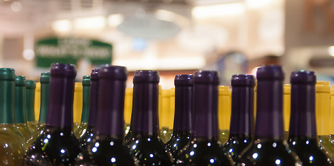 Image showing Wine bottles shot with limited depth of field on display in a li