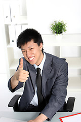 Image showing Asian businessman giving a thumbs up