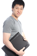 Image showing Young Asian Man Holding a Black Binder