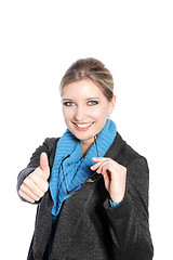 Image showing Woman in winter attire giving a thumbs up