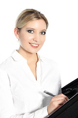 Image showing Beautiful young woman writing in a file