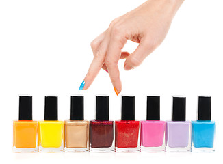 Image showing Female hand fingers are the colored paints polish