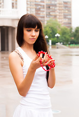 Image showing Pretty girl with red beads