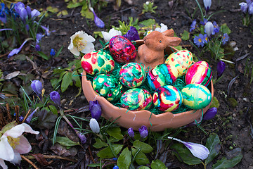Image showing Easter basket amongst spring crocus flowers