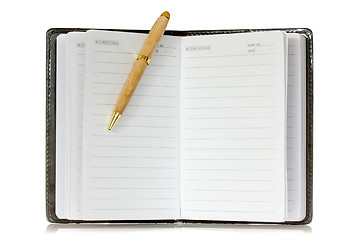 Image showing Notebook and pen with reflection on white background