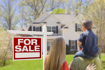 Image showing Family Facing For Sale Real Estate Sign and House