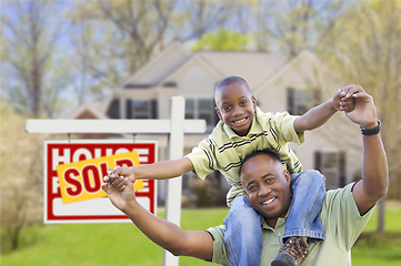 Image showing Father and Son In Front of Real Estate Sign and Home