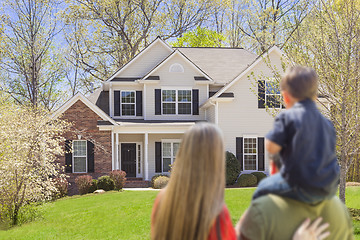 Image showing Mixed Race Young Family Looking At Beautiful Home