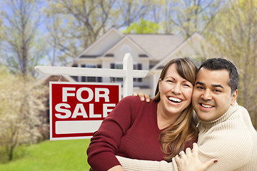 Image showing Couple in Front of For Sale Sign and House