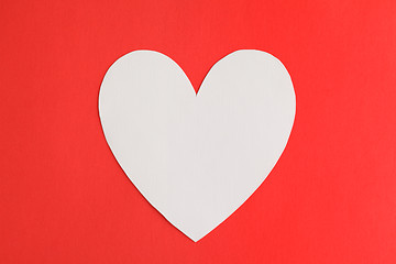 Image showing Heart shape paper over red paper background