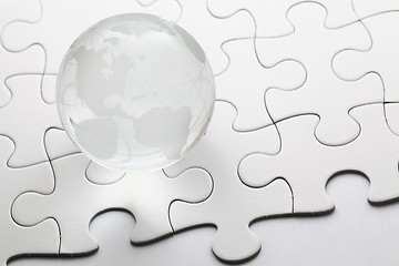 Image showing glass globe with puzzle background