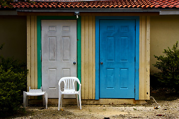 Image showing door and broke plastic chair