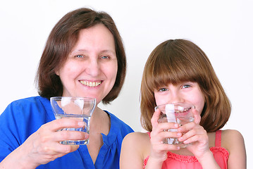 Image showing Smiling woman and girl drink water