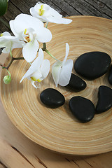 Image showing Spa massage stones and orchids