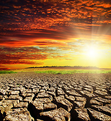 Image showing drought earth with red clouds and sunset