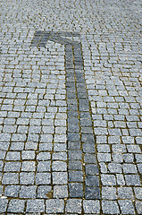 Image showing cobbled road with arrow as background