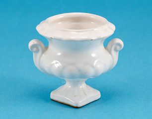 Image showing ceramic white small vase dish on blue background 