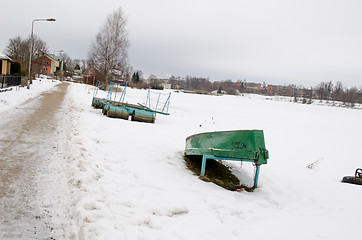 Image showing dock barrel wooden upturn boat snow season winter 