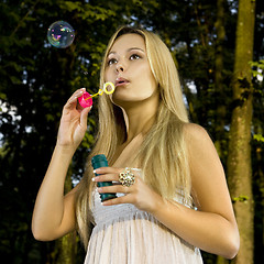 Image showing blonde blowing soap bubble